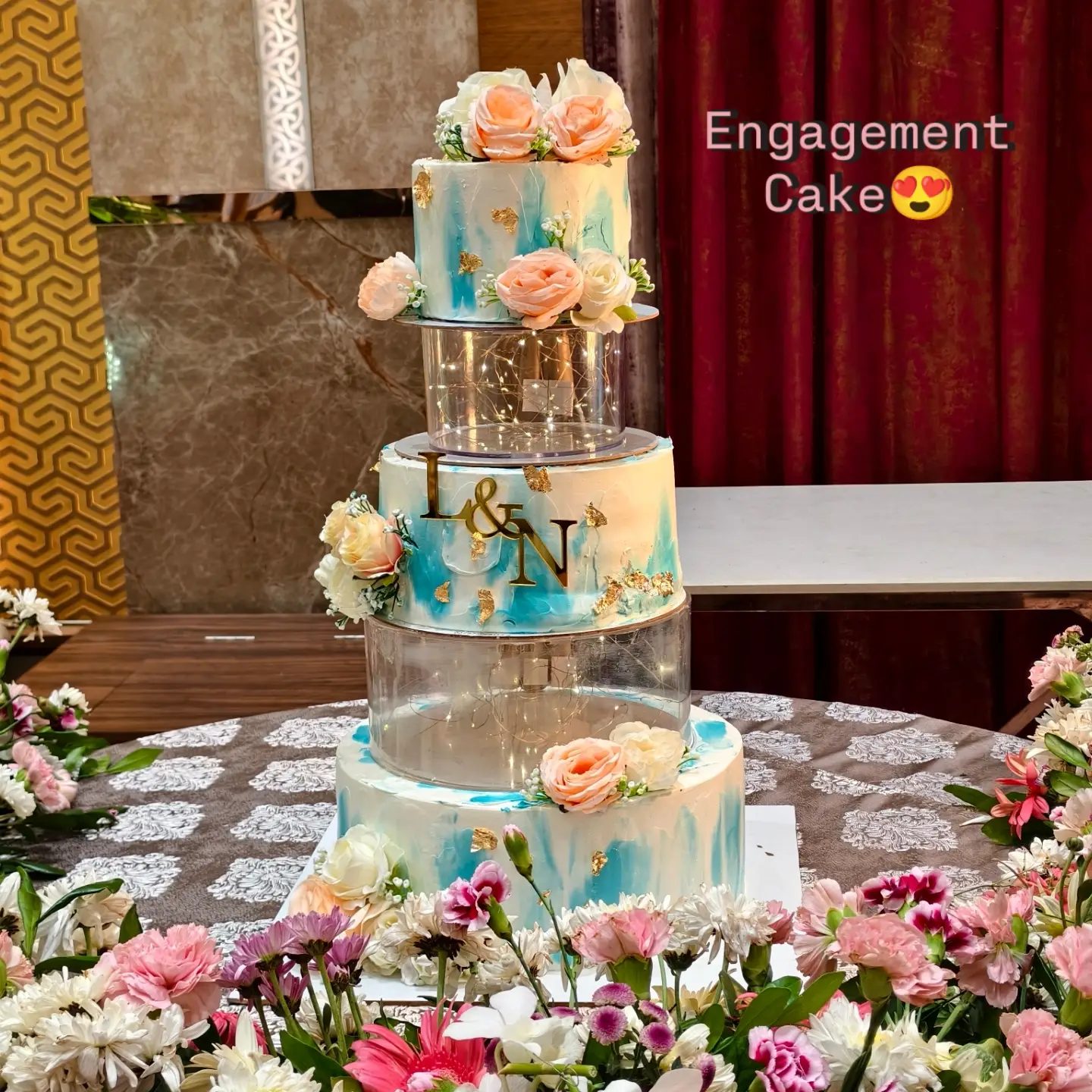 Blue and peach tiered engagement cake